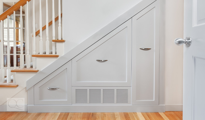 storage space built into the staircase as designed by a professional organizer