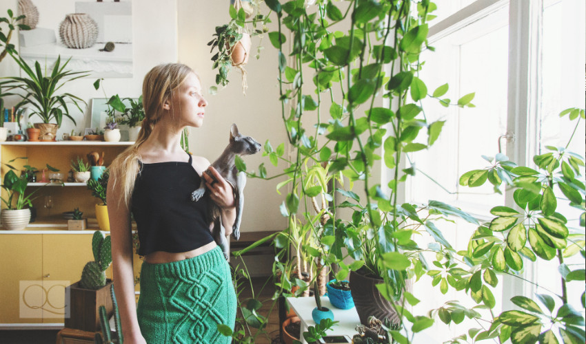 girl living in a home with lots of sunlight and plenty of plants