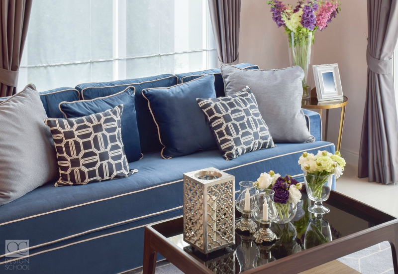 Denim blue sofa in neutral toned living room.