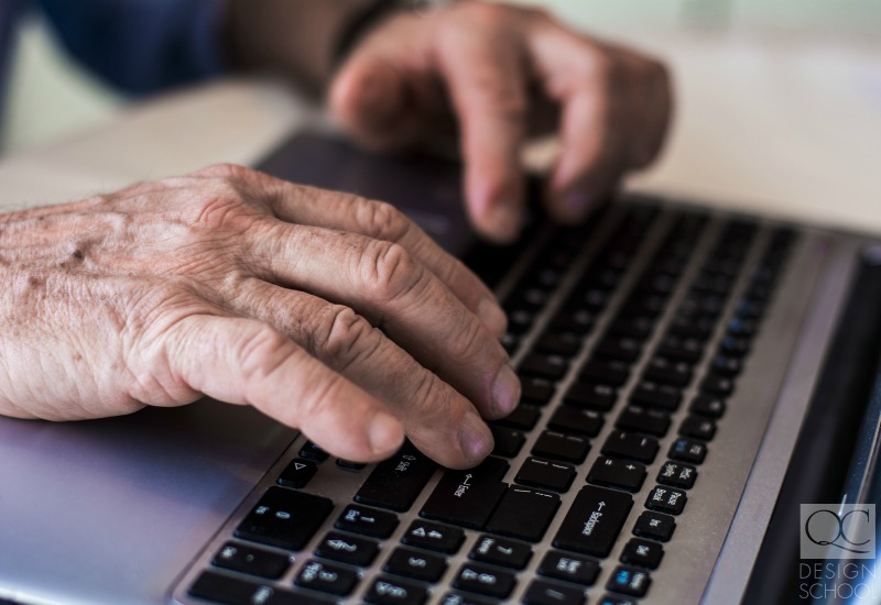 retired hands on a keyboard surfing the web