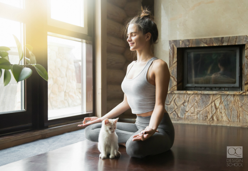 girl doing yoga in her living room with kitten