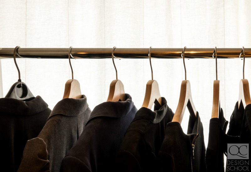 hanging black coats in a closet