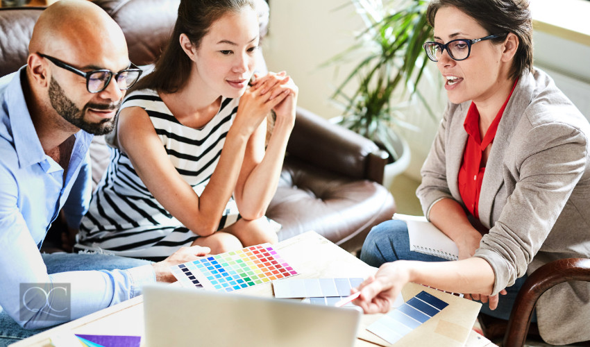 interior decorator discussing interior designs with her clients