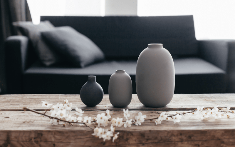 minimalistic grey and black pot decor on wooden coffee table