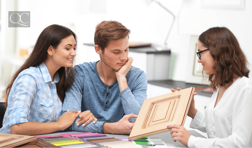 interior decorator shows happy couple a wooden sample