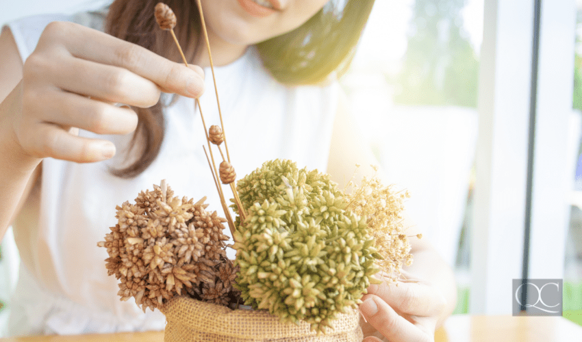 woman working on flower arrangement