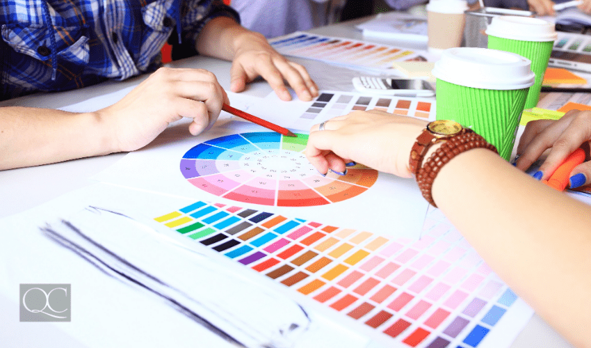 color consultant showing clients color wheel and swatches at table