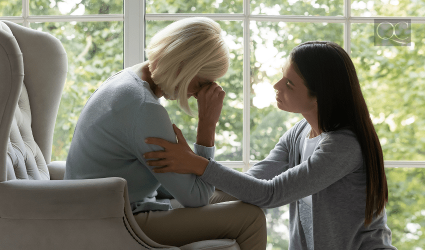 woman empathetically listening to upset elderly woman