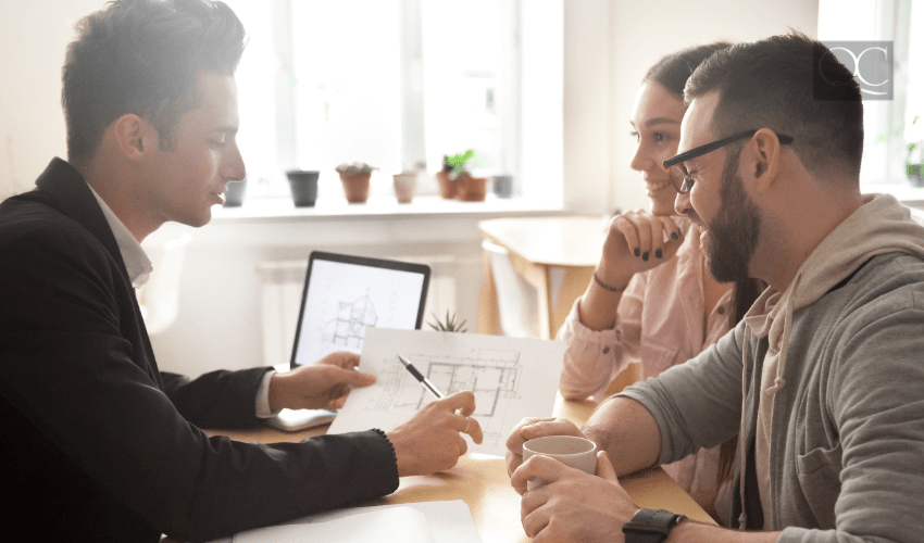 designer talking with clients at desk