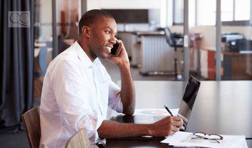 male professional on the phone and taking notes