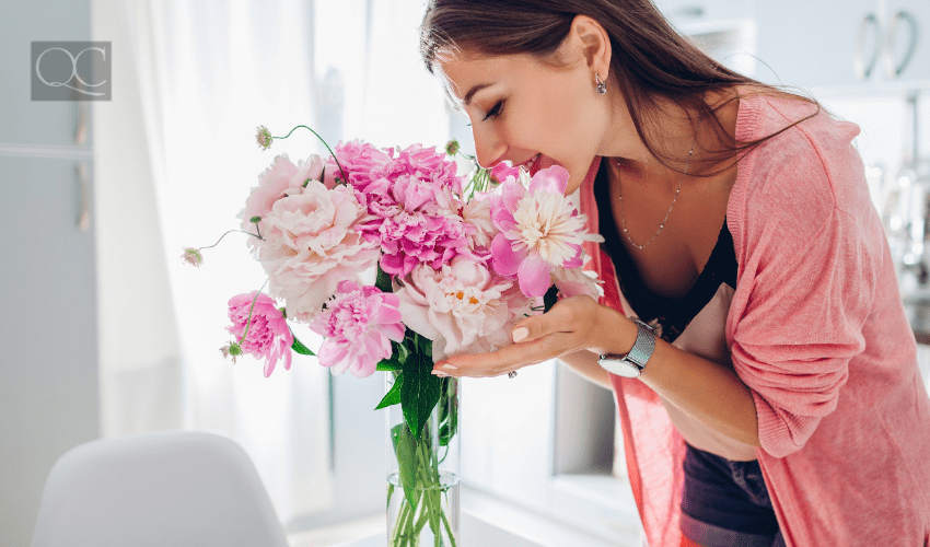 woman smelling flowers