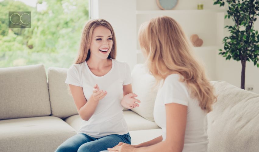 Two women casually chatting in living room