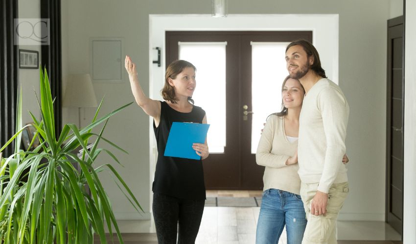 Interior decorator showing house to client couple