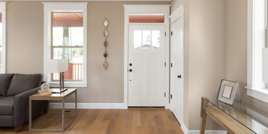 Foyer and entryway in new home with hardwood floors, couch, lamp. Feng Shui article.